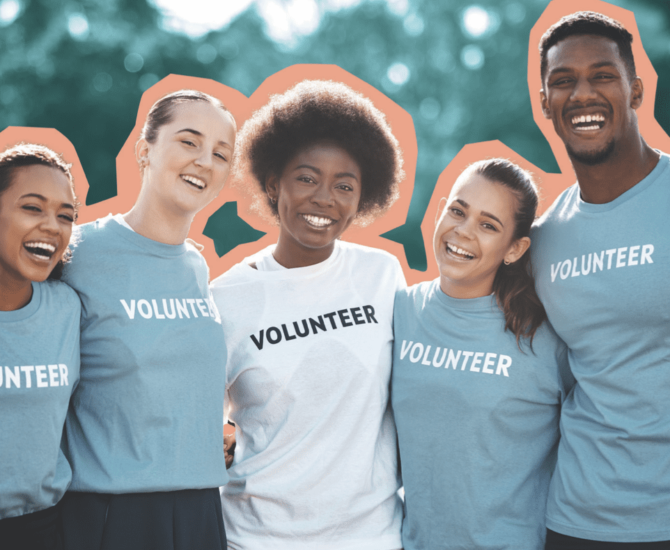 A group of volunteers embraces with smiles on their faces